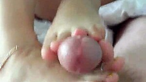 Asian girlfriend gives a footjob and gets off on camera