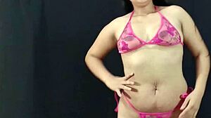 Young and curvy Latina beauty flaunts her assets in pink lingerie and prepares for a steamy photo shoot